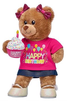 a brown teddy bear holding a birthday cupcake