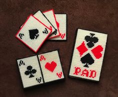 four playing cards with the word dad written on them and two hearts in each card