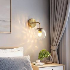 a bedroom scene with focus on the bedside table and light fixture, which is hanging from the wall