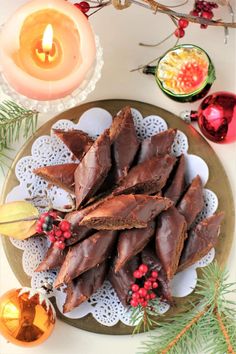 chocolate christmas treats on a plate with candles and decorations