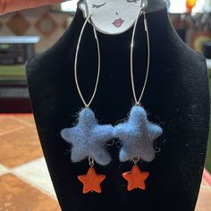 a black mannequin with two blue and orange stars hanging from it's sides