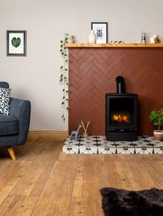 a living room with a fire place in the corner and a chair next to it