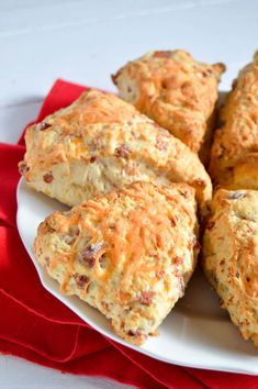 several biscuits on a white plate with red cloth