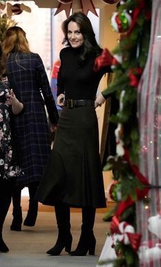 two women standing in front of christmas decorations