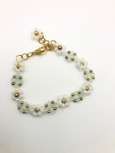 Looking for a piece of jewellery that exudes elegance and sophistication? Look no further than our sage green Rainflower bracelet! Crafted with the finest materials, this bracelet boasts stunning sage green gems and white glass flowers. The intricate design of this piece is truly mesmerizing, making it an ideal accessory for any occasion. Whether you're attending an upscale event or simply looking to add some flair to your everyday attire, this gorgeous Rainflower Bracelet is sure to make a stat Sage Green Accessories, Sage Green Bracelet, Mykonos Blue, Silver Sage, Green Accessories, Gift For Her Birthday, Green Gems, Free Bracelet, Glass Flowers