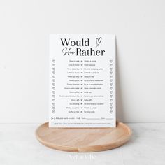 a sign that says would she be rather than you? on top of a wooden plate