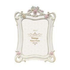 an ornate white frame with pink flowers on the edges and gold lettering that reads vintage picture frame