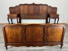 an antique wooden bed frame with two nightstands