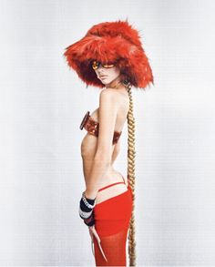 a woman with long braids and a red hat on her head is standing in front of a white background