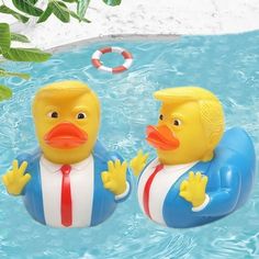 two rubber ducks in the water with life rings