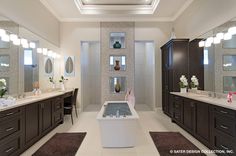 a large bathroom with two sinks and mirrors