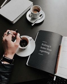 a person sitting at a table with a book and cup of coffee