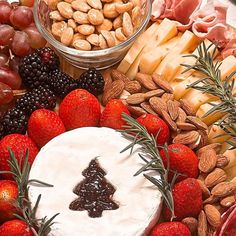 a platter with cheese, fruit and nuts