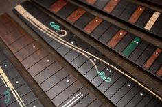 an overhead view of several rows of wooden boards with green and white designs on them