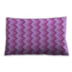 a pink and purple chevroned pillow on a white background