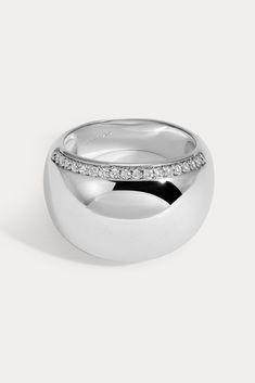 Bold and lightweight, this smooth domed design is embellished with pavé detailing along both edges of the ring. Available in 14kt gold plated brass or Rhodium plated brass Stones are White Cz, and measure 1.0mm each Dome width measures approx. 15mm Dome height measures approx. 4mm Runs true to size Product Care: METAL: Use a soft cloth to gently wipe clean, then remove any remaining impurities with mild diluted soap. Rinse with warm water and dry thoroughly before storing in the provided jewelry Lili Claspe Jewelry, Dome Ring, Domed Ring, Platinum Ring, Jewelry Cleaner, 14kt Gold, Jewelry Pouch, Warm Water, Rhodium Plated