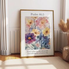 a painting on the wall with a bible verse below it and a vase full of flowers