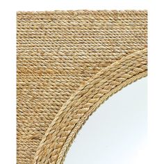 a close up of a mirror on a wicker table cloth with a white background