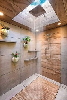 a bathroom with a skylight above the shower and wooden flooring on the walls