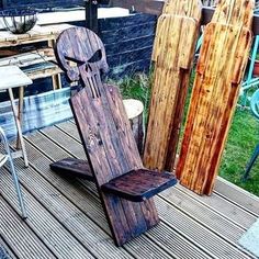 two wooden sleds are sitting on a deck with chairs and tables in the background