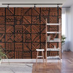 an orange and black wall mural in a living room