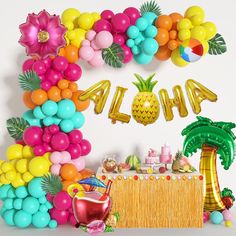 a tropical themed birthday party with balloons and decorations