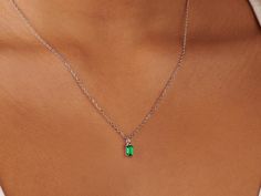 A dainty stone and delicate metallic chain are combined to create this silver Pendant Necklace in bright emerald, your new favorite wear-anywhere accessory. The birthstone for the month of May is Emerald. This translucent green gemstone increases generosity, improves decision-making, and symbolizes compassion. High-quality lab-created emerald stone; Made of sterling silver. Pendant size: 6mm x 4mm with 18" chain. Hypoallergenic, nickel, and lead-free. Tarnish resistant. Ideas to choose your Birt Dainty Silver Emerald Pendant Necklace, Dainty Silver Pendant Emerald Necklace, Silver Necklace With Delicate Chain For May Birthstone, Delicate Chain Emerald Necklace For May Birthstone, May Birthstone Necklace With Clavicle Chain, Sterling Silver Emerald Necklace, Dainty Silver Emerald Necklace, Dainty Green Gemstone Birthstone Necklace, Dainty Green Birthstone Necklace For Everyday