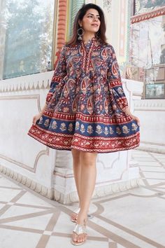 Discover the charm of traditional Indian craftsmanship with our exquisite Kalamkari Jaipuri print knee-length dress. Handcrafted from soft Indian cotton, this dress features a captivating blend of vibrant blue and rich red hues in intricate Jaipuri patterns. Perfect for both casual and festive occasions, it offers comfort, style, and a touch of cultural elegance. Elevate your wardrobe with this unique piece that celebrates India's rich textile heritage Model is wearing size S and is 5'feet 4 inc Multicolor Dresses With Traditional Patterns For Diwali, Traditional Multicolor Straight Kurta Dress, Traditional Paisley Print Kurta For Festivals, Traditional Kurta With Paisley Print For Festivals, Traditional Straight Kurta Dress With Printed Motifs, Cotton Long Sleeve Dress For Diwali, Red Cotton Dress With Bandhani Print, Diwali Cotton Long Sleeve Dresses, Long Sleeve Cotton Dress For Diwali