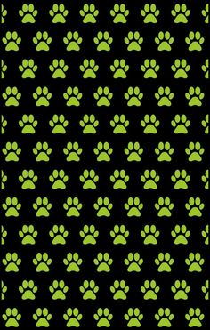 a black background with green dog paw prints