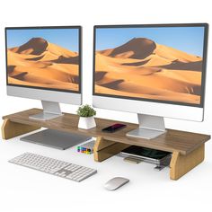 two computer monitors sitting next to each other on top of a wooden desk with keyboard and mouse