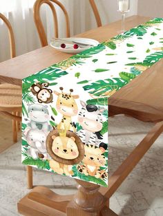 an animal themed table runner on top of a wooden table