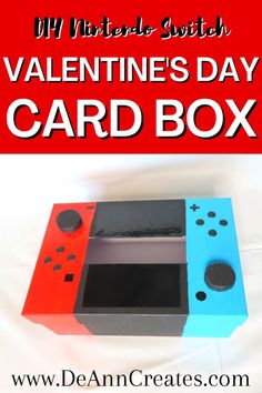 This pin says DIY Nintendo Switch Valentine's Day Card Box by DeAnn Creates.  The picture shows a cardboard box with a slit in the center decorated to look like a Nintendo Switch.  The left side is painted red, the right side is blue, and the center is black. Easy Valentines Day Boxes, Diy Valentine's Mailbox, Homemade Valentine Boxes, Box Ideas For Kids, Valentine Boxes For School, Diy Valentines Box, Kids Valentine Boxes