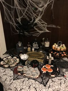 a table topped with lots of halloween treats