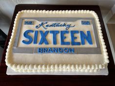 a cake that is sitting on top of a wooden table with the name sixteen brandon written on it