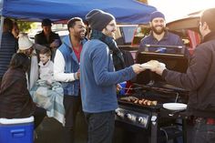 people are standing around an open grill with food on it and the words 12 tailgating recipes to try