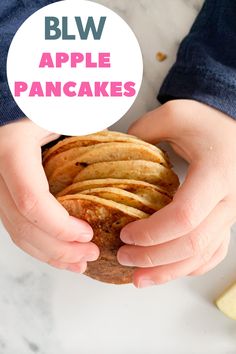 a person holding up a sandwich with apples on it and the text blw apple pancakes