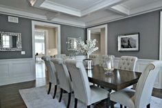 a dining room table and chairs with white trim