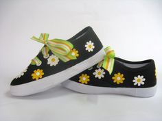 PLEASE SEE OUR SIZE CHART TO SELECT YOUR SIZE. SHOES TEND TO RUN SMALL. These cute daisy shoes have a striking design. We hand painted beautiful yellow and white flowers on our black canvas sneakers. We have added a bright yellow ribbon for the laces. Ribbons may vary according to availability. Perfect for summer time fun. PLEASE use our size chart below when selecting your size as some think they tend to run small. Some think the shoes are not sized like national brands. Measurements are taken Spring Yellow Canvas Shoes With Rubber Sole, Yellow Slip-on Canvas Shoes For Spring, Yellow Lace-up Canvas Shoes For Spring, Yellow Canvas Sneakers For Spring, Cute Yellow Sneakers For Spring, Cute Spring Canvas Shoes With Rubber Sole, Cute Canvas Shoes With Rubber Sole For Spring, Cute Summer Canvas Shoes With Rubber Sole, Fun Yellow Sneakers For Spring