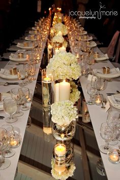 a long table with white flowers and candles on it is seen in the instagram page