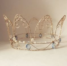 a gold tiara with blue glass beads