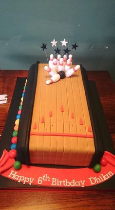 a birthday cake with bowling pins on it