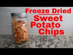 a jar filled with potato chips sitting on top of a counter