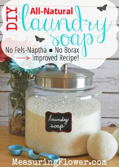 a glass jar filled with laundry soap next to flowers