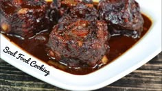 meatballs with sauce in a white bowl on a wooden table