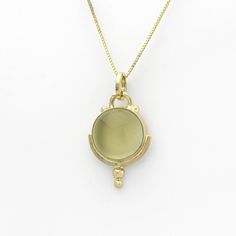 This lovely golden moonstone amulet is SASA's trademarked Art Deco style in a handmade 14K yellow gold setting. Little solid 'bubbles' of gold on the tip add sparkle when light falls upon them. According to Hindu mythology, moonstone is made of solidified moonbeams. Many other cultures also associate this gem with moonlight, and it's easy to see why. Its internal structure scatters the light that strikes it, creating a phenomenon known as adularescence. The visual effect is reminiscent of the fu Heirloom Style Yellow Gold Cabochon Jewelry, Yellow Gold Moonstone Jewelry, Unique Yellow Gold Moonstone Jewelry, Antique Yellow Gold Necklace With Cabochon, Formal Yellow Gold Moonstone Jewelry, Handmade Moonstone Jewelry In Yellow Gold, Handmade Yellow Gold Moonstone Jewelry, Round Brass Jewelry With Bezel Setting, Gold Jewelry With Bezel Setting In Recycled Gold