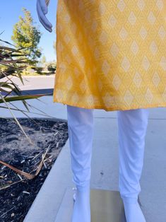 Premium quality Yellow Color Silk Men's Kurta Pajama Set with design pattern all over the Kurta. The neckline has lace work and fancy buttons. Item : Men's Kurta PajamaReady to Wear : YesPocket : YesKurta Color : Yellow Pajama Color : Cream/White Fabric : SilkLining : Yes Work : Fancy buttons, Woven Zari work, Lace WorkPattern : DesignerDisclaimer-For sizing please refer to the Size Chart given in the listing with the pictures.- Please do NOT go by the size of the Kurta that you already have fro Traditional Straight Kurta In Cotton, Traditional Cotton Straight Kurta Bottoms, Traditional Cotton Bottoms With Printed Motifs, Traditional Pants With Printed Motifs For Eid, Traditional Bottoms With Printed Motifs For Eid, Traditional Yellow Cotton Bottoms, Traditional Fitted Pants With Printed Motifs, Fitted Traditional Pants With Printed Motifs, Yellow Pajamas