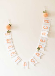 an orange and white sign that says sweet as a peach hanging on the wall with flowers