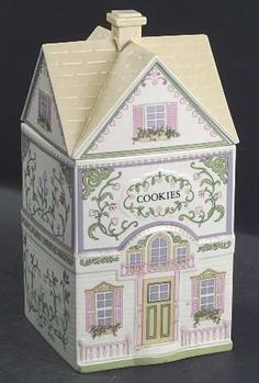 a small white house with pink trimmings on the roof and windows, painted in pastel colors