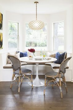 a dining room table with two chairs and a bench