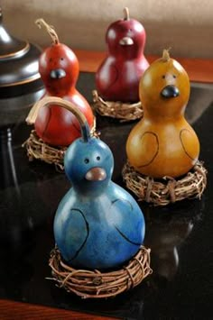 four ceramic birds sitting on top of a table